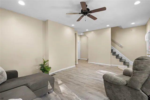 a living room with furniture and a potted plant