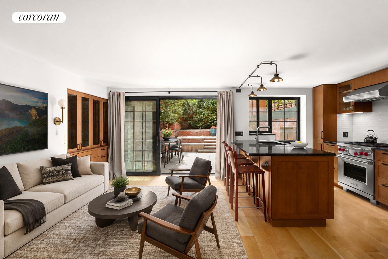 21 Bethune Street, Unit GARDEN Manhattan, NY 10014 - Photo 1 of 8 a living room with furniture kitchen view and a large window