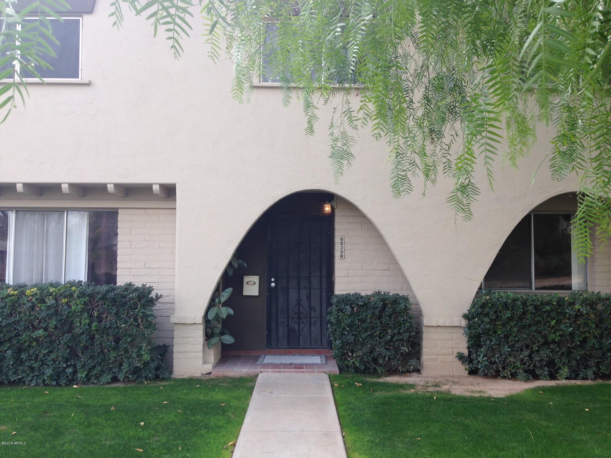 6829 East Osborn Road, Unit B Scottsdale, AZ 85251 - Photo 1 of 20 a front view of a house with garden