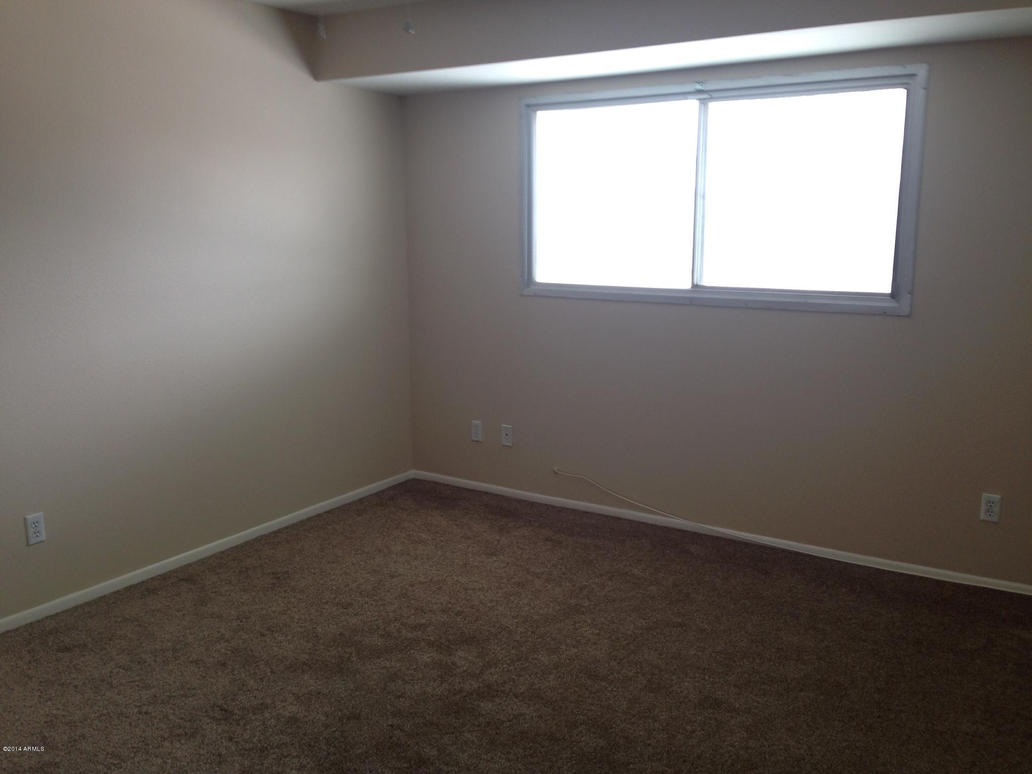 6829 East Osborn Road, Unit B Scottsdale, AZ 85251 - Photo 12 of 20 an empty room with a window