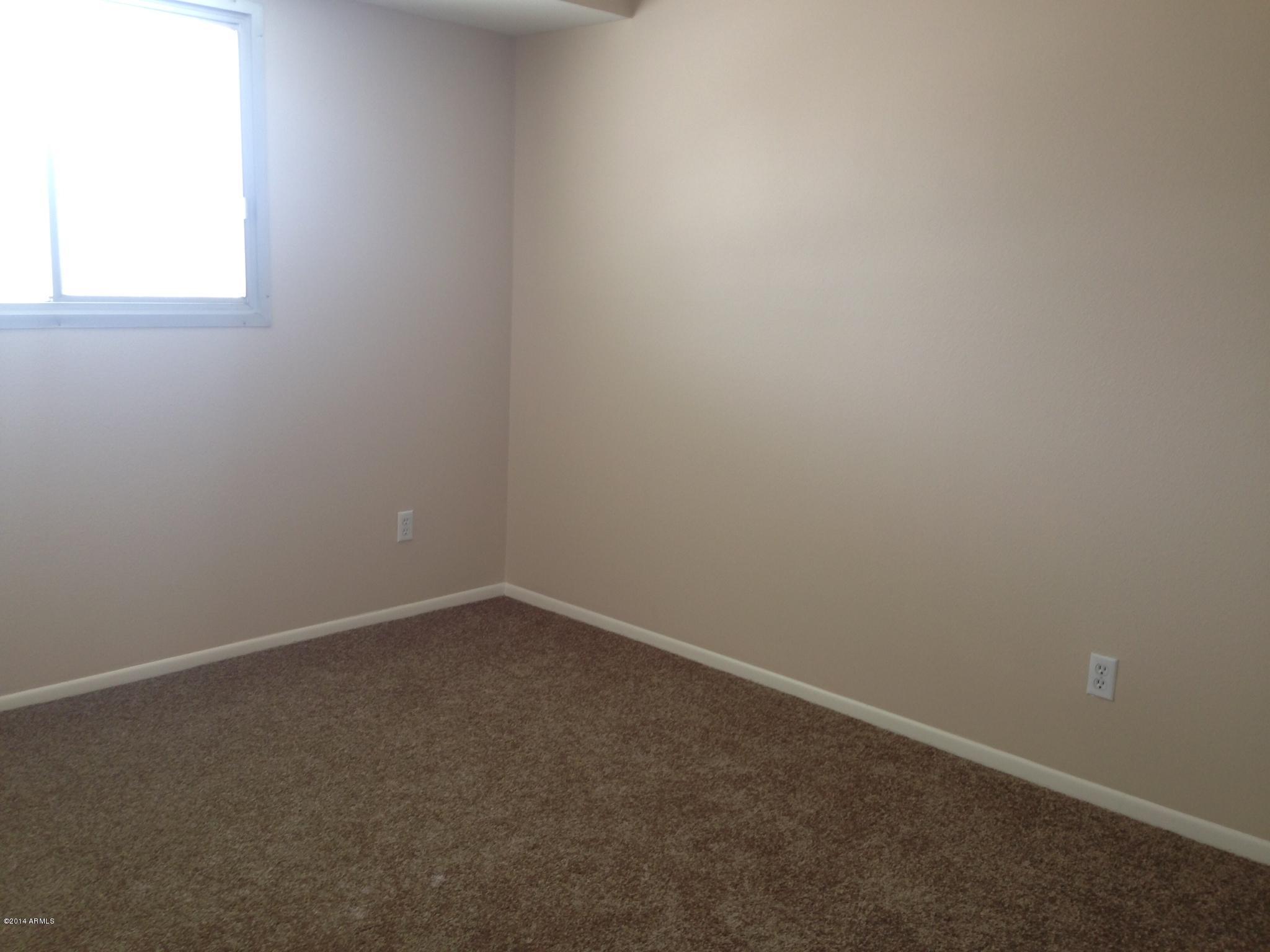 6829 East Osborn Road, Unit B Scottsdale, AZ 85251 - Photo 14 of 20 an empty room with a window