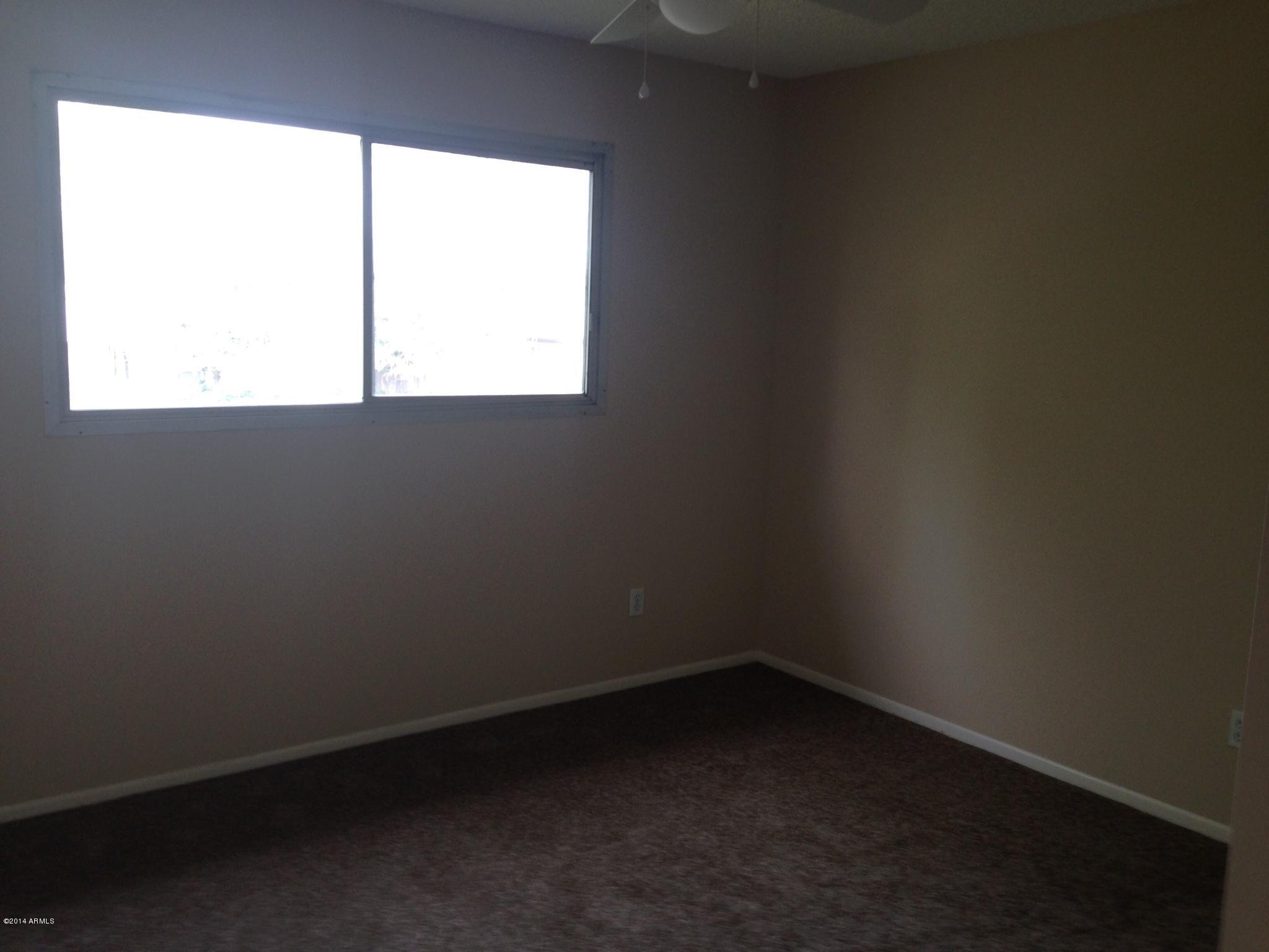 6829 East Osborn Road, Unit B Scottsdale, AZ 85251 - Photo 16 of 20 an empty room with a window