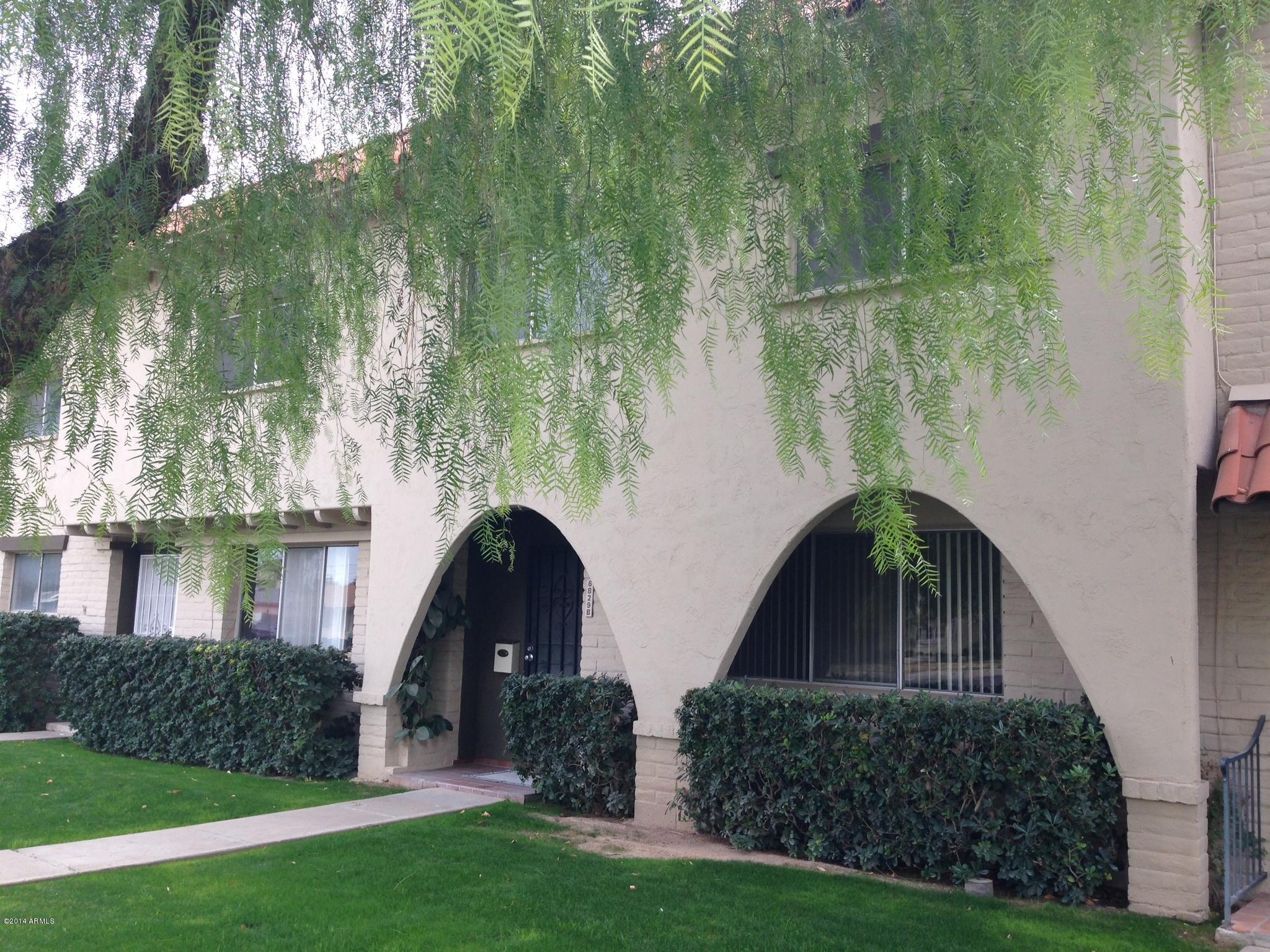 6829 East Osborn Road, Unit B Scottsdale, AZ 85251 - Photo 2 of 20 a front view of a house with a yard