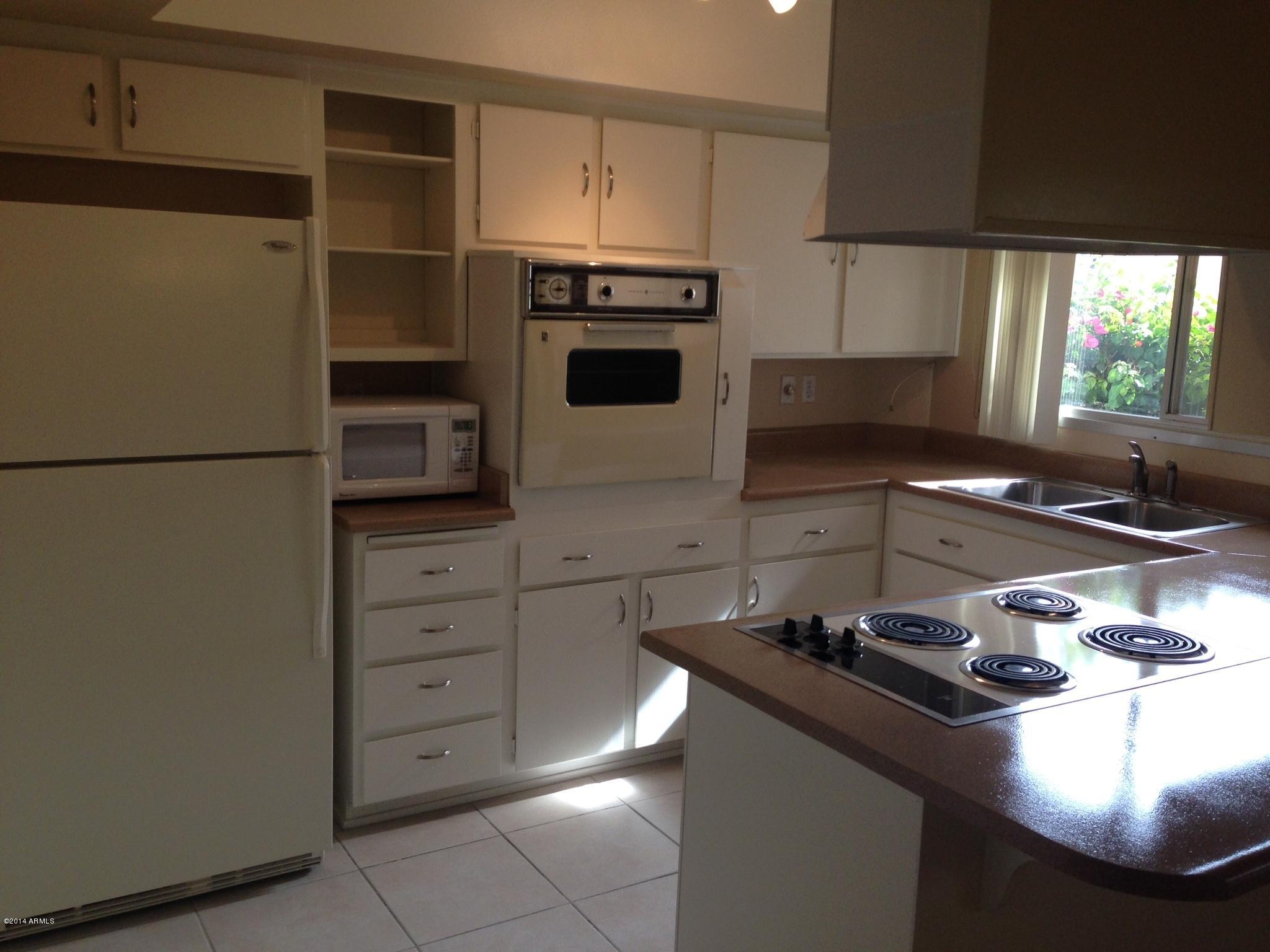 6829 East Osborn Road, Unit B Scottsdale, AZ 85251 - Photo 4 of 20 a kitchen with appliances and cabinets
