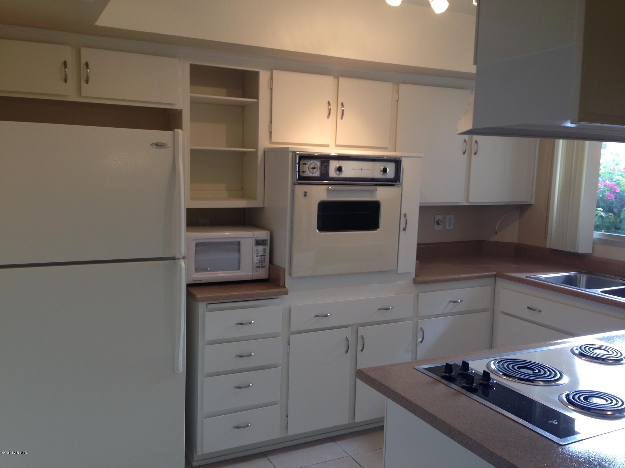 6829 East Osborn Road, Unit B Scottsdale, AZ 85251 - Photo 5 of 20 a kitchen with a stove and a refrigerator