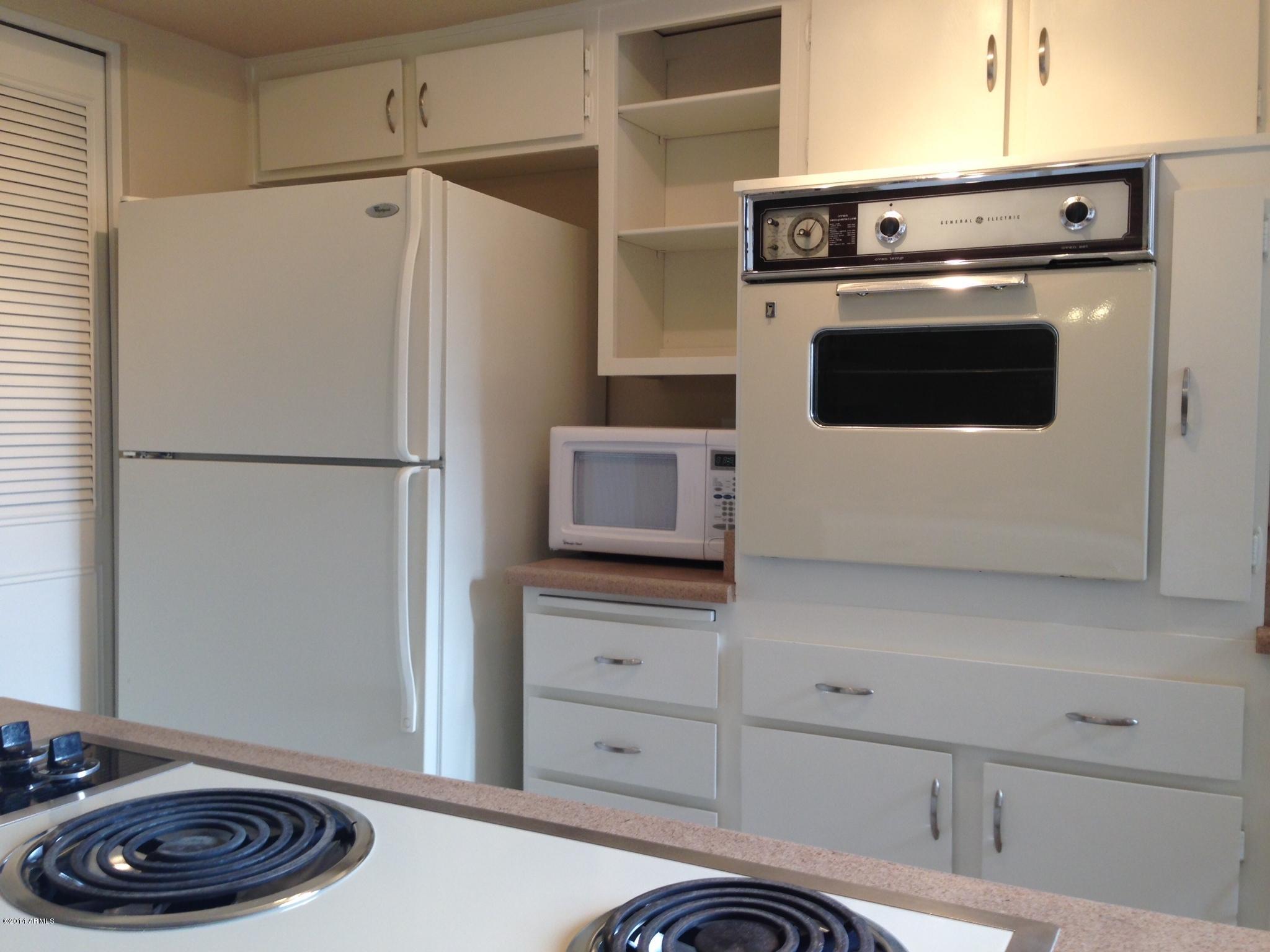 6829 East Osborn Road, Unit B Scottsdale, AZ 85251 - Photo 6 of 20 a kitchen with a refrigerator and a stove