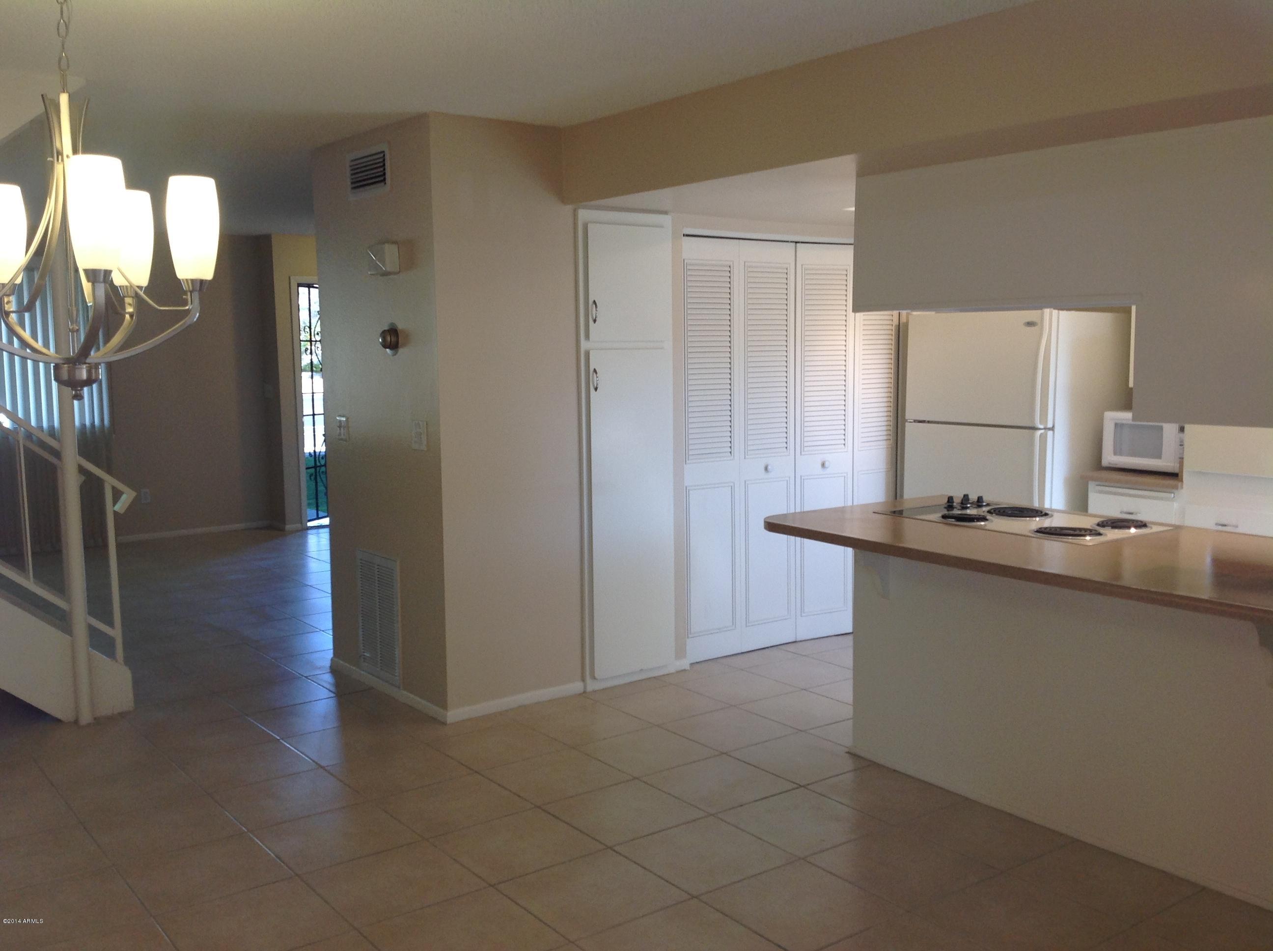 6829 East Osborn Road, Unit B Scottsdale, AZ 85251 - Photo 7 of 20 a kitchen with stainless steel appliances a sink stove and cabinets
