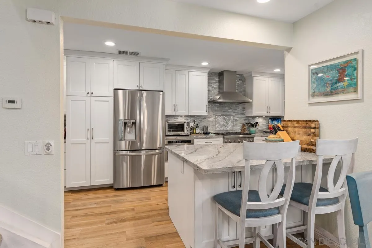 13350 Birch Tree Lane Poway, CA 92064 - Photo 13 of 43 a kitchen with stainless steel appliances granite countertop a refrigerator and a stove top oven