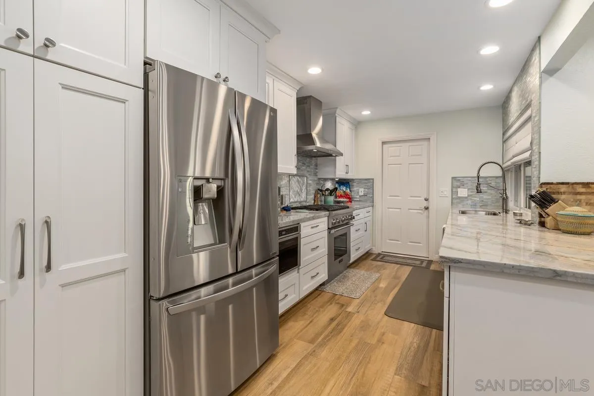 13350 Birch Tree Lane Poway, CA 92064 - Photo 14 of 43 a kitchen with stainless steel appliances a refrigerator sink and microwave