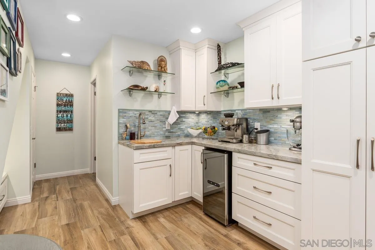 13350 Birch Tree Lane Poway, CA 92064 - Photo 16 of 43 a kitchen with granite countertop white cabinets and white appliances