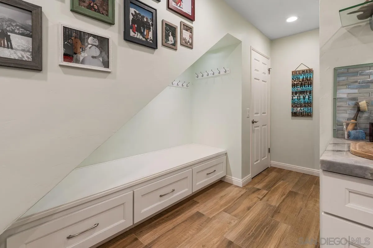 13350 Birch Tree Lane Poway, CA 92064 - Photo 17 of 43 a view of hallway with cabinet and wooden floor
