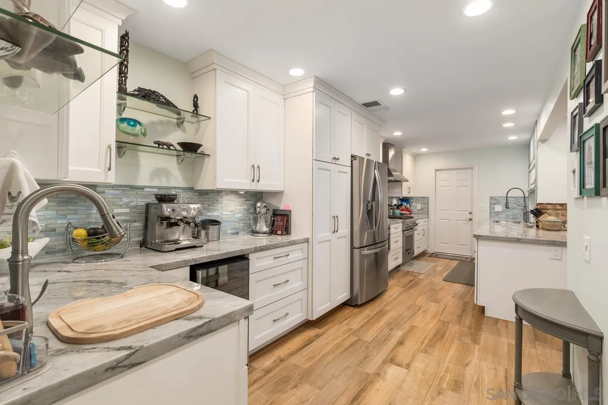 13350 Birch Tree Lane Poway, CA 92064 - Photo 7 of 43 a kitchen with a refrigerator and a sink