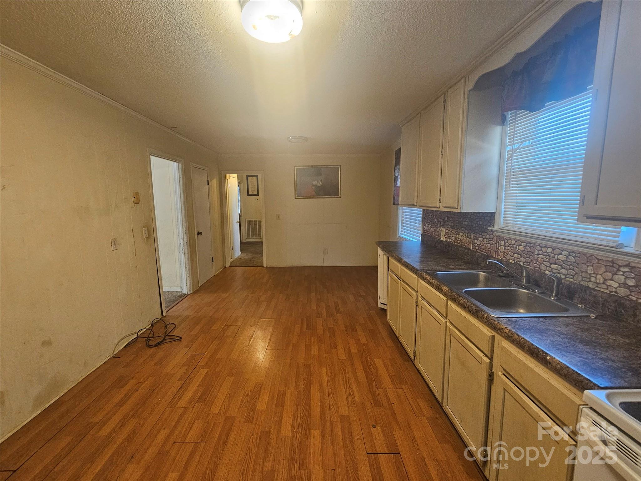 3406 West End Road Carlisle, SC 29031 - Photo 2 of 13 a view of a kitchen with wooden floor and cabinets