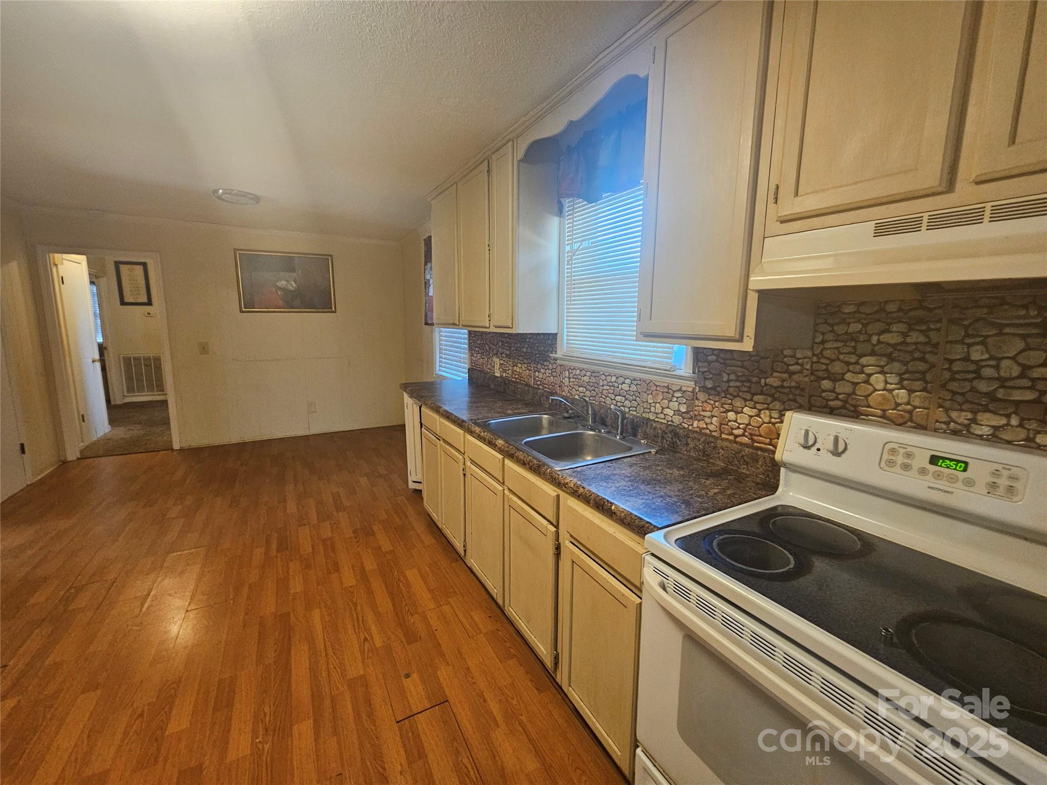 3406 West End Road Carlisle, SC 29031 - Photo 3 of 13 a kitchen with wooden floors and a stove