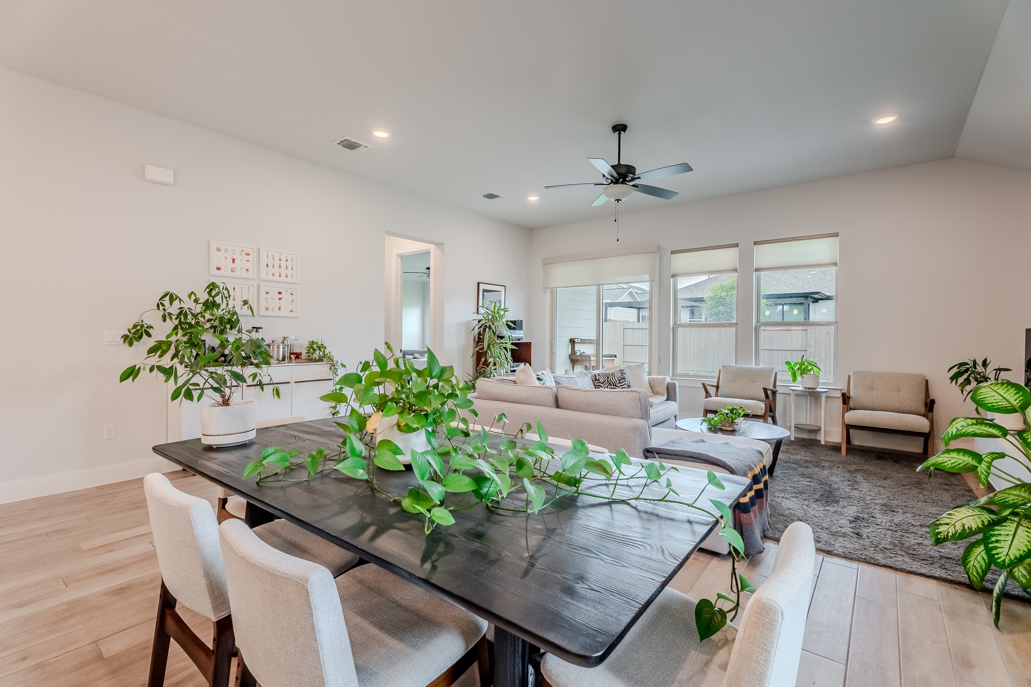 8109 Edmondson Bend Austin, TX 78744 - Photo 25 of 38 Natural light floods this inviting living space, connecting seamlessly with the dining area for a harmonious flow.