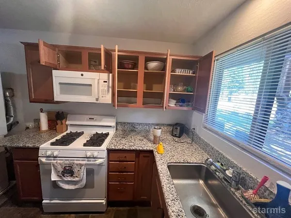 a kitchen that has a sink and a stove