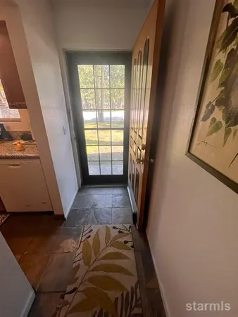 a view of bedroom with window and wooden floor
