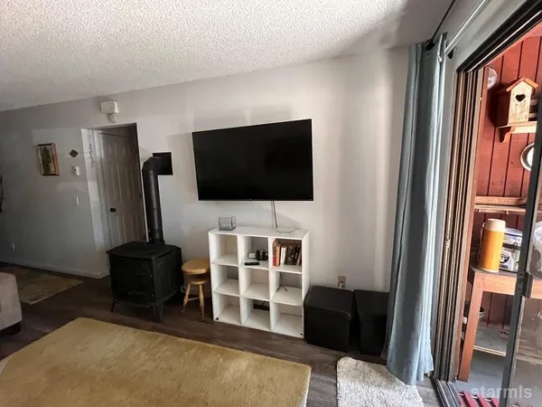 a view of a livingroom with furniture and a flat screen tv
