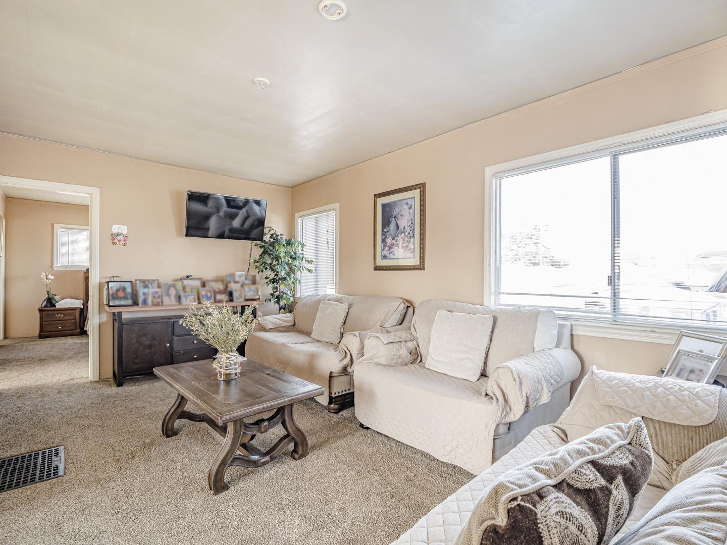 9 Memorial Avenue Freedom, CA 95019 - Photo 11 of 18 a living room with furniture a rug and a large window