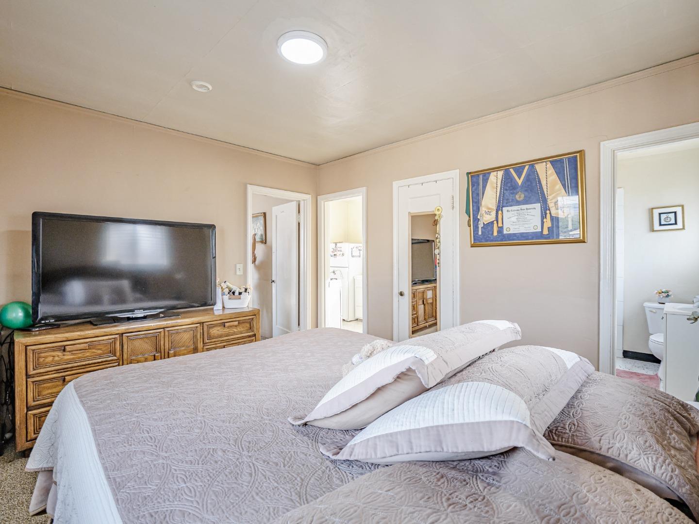 9 Memorial Avenue Freedom, CA 95019 - Photo 13 of 18 a bedroom with a bed and a flat screen tv