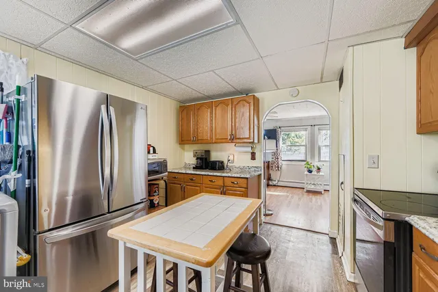 a kitchen with stainless steel appliances a refrigerator sink and stove