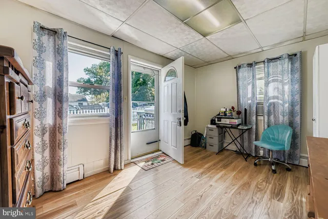 a view of a livingroom with wooden floor and furniture