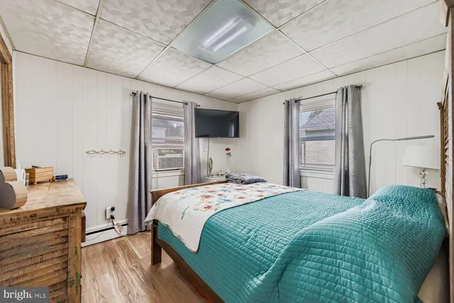 a bedroom with a bed and a flat tv screen