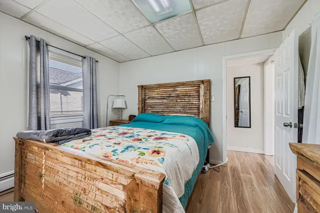 a bedroom with a bed next to a window