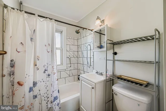 a bathroom with a shower a toilet and sink