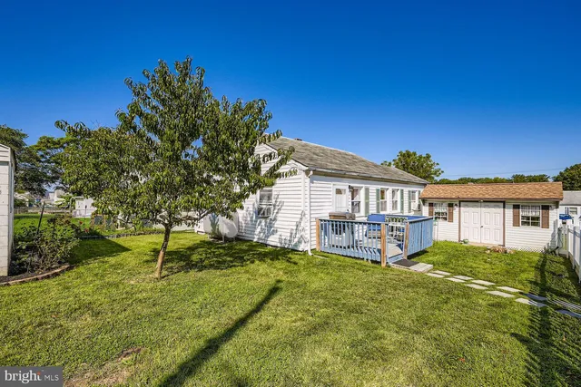 a view of a house with a yard and sitting area