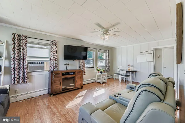 a living room with furniture fireplace and flat screen tv