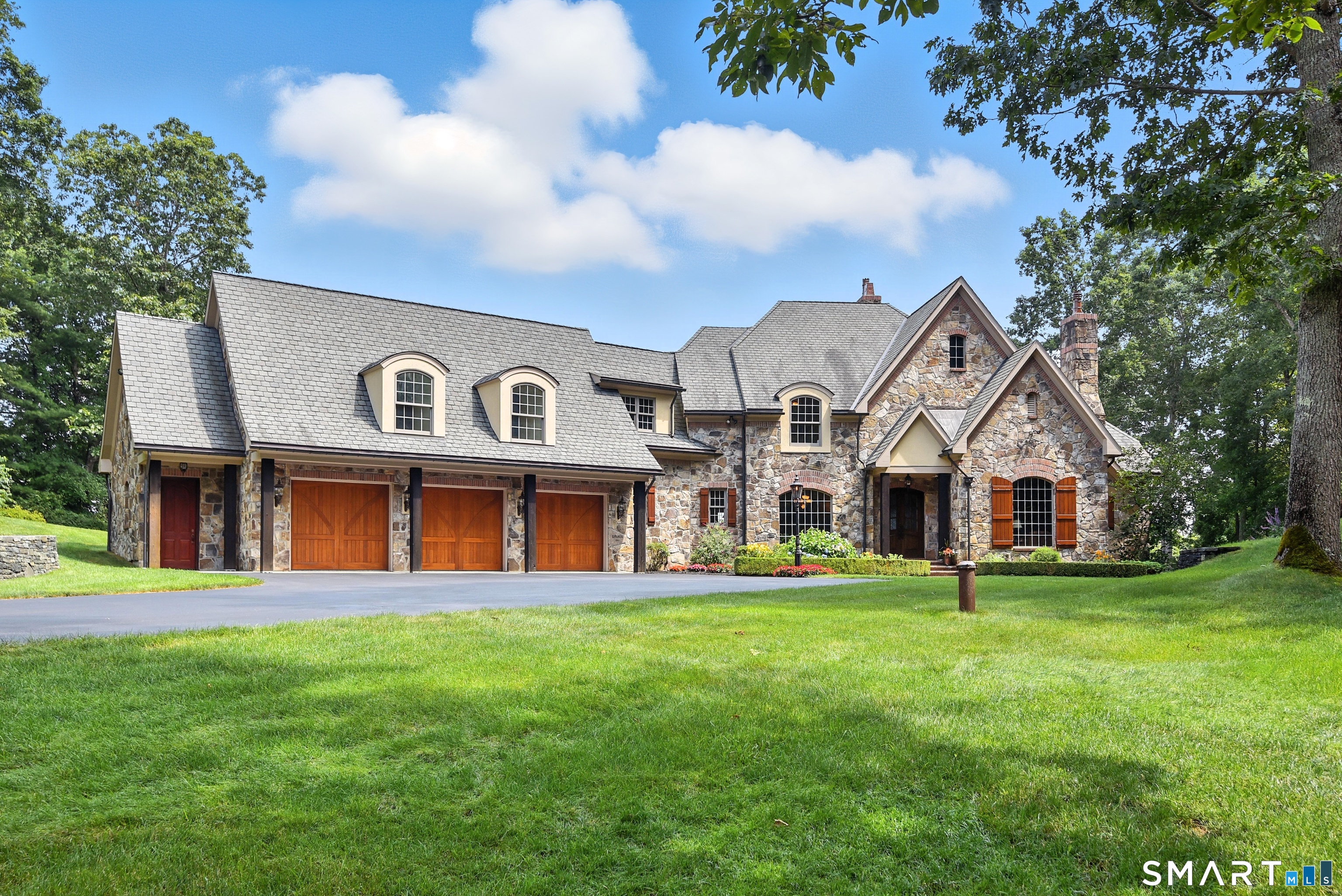 282 Searles Road Pomfret, CT 06259 - Photo 1 of 40 Rare country estate offering privacy, luxury, and elegance. Crowning the roof are three imported glazed chimney pots from England, paired with handcrafted copper gutters and valleys.