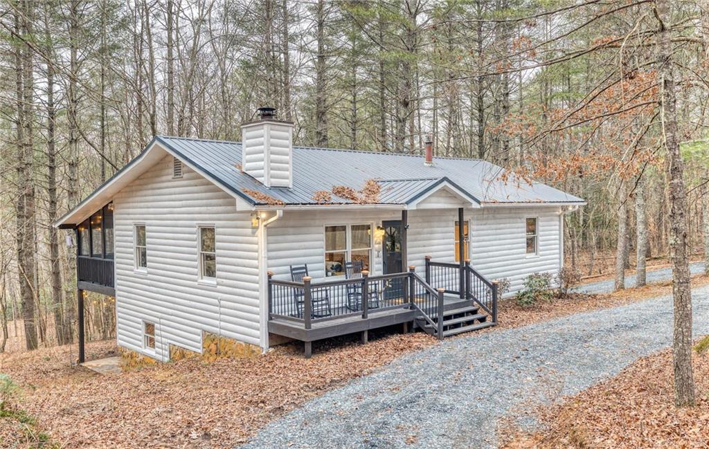 357 Mystic Lane Blue Ridge, GA 30513 - Photo 1 of 1 a view of a house with a yard chairs and wooden fence