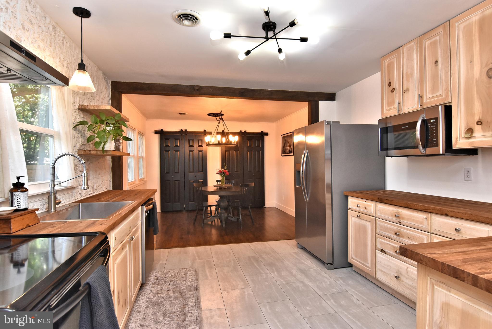 9012 Concord Road Seaford, DE 19973 - Photo 3 of 24 a kitchen with stainless steel appliances granite countertop a sink a stove and a refrigerator