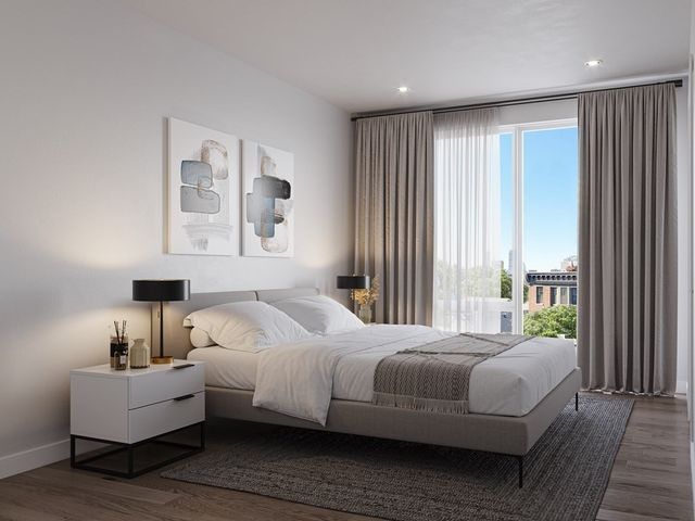 a bedroom with a bed and a large window