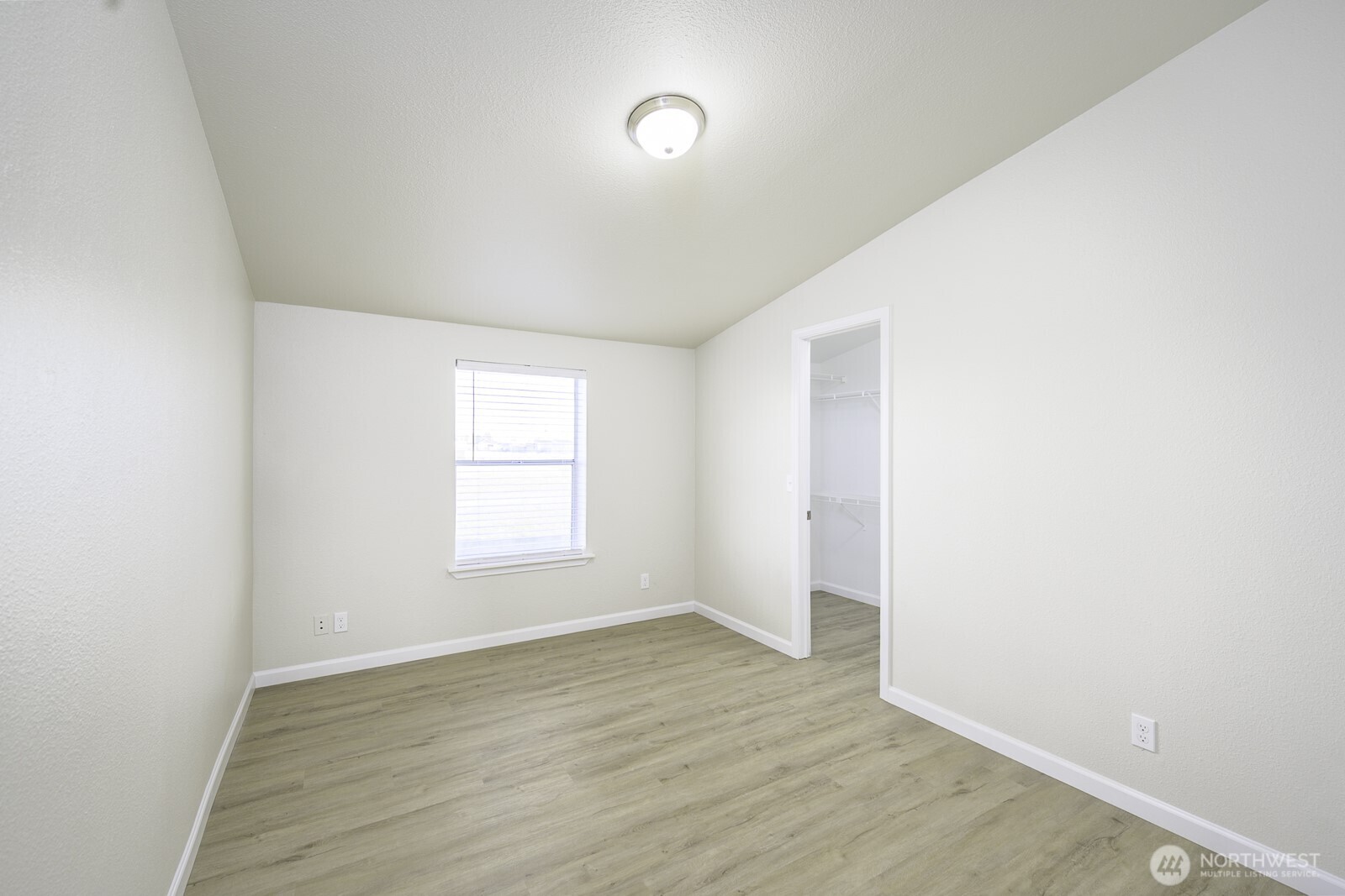 4948 Northeast E 7 Road Moses Lake, WA 98837 - Photo 12 of 22 a view of an empty room with wooden floor and a window