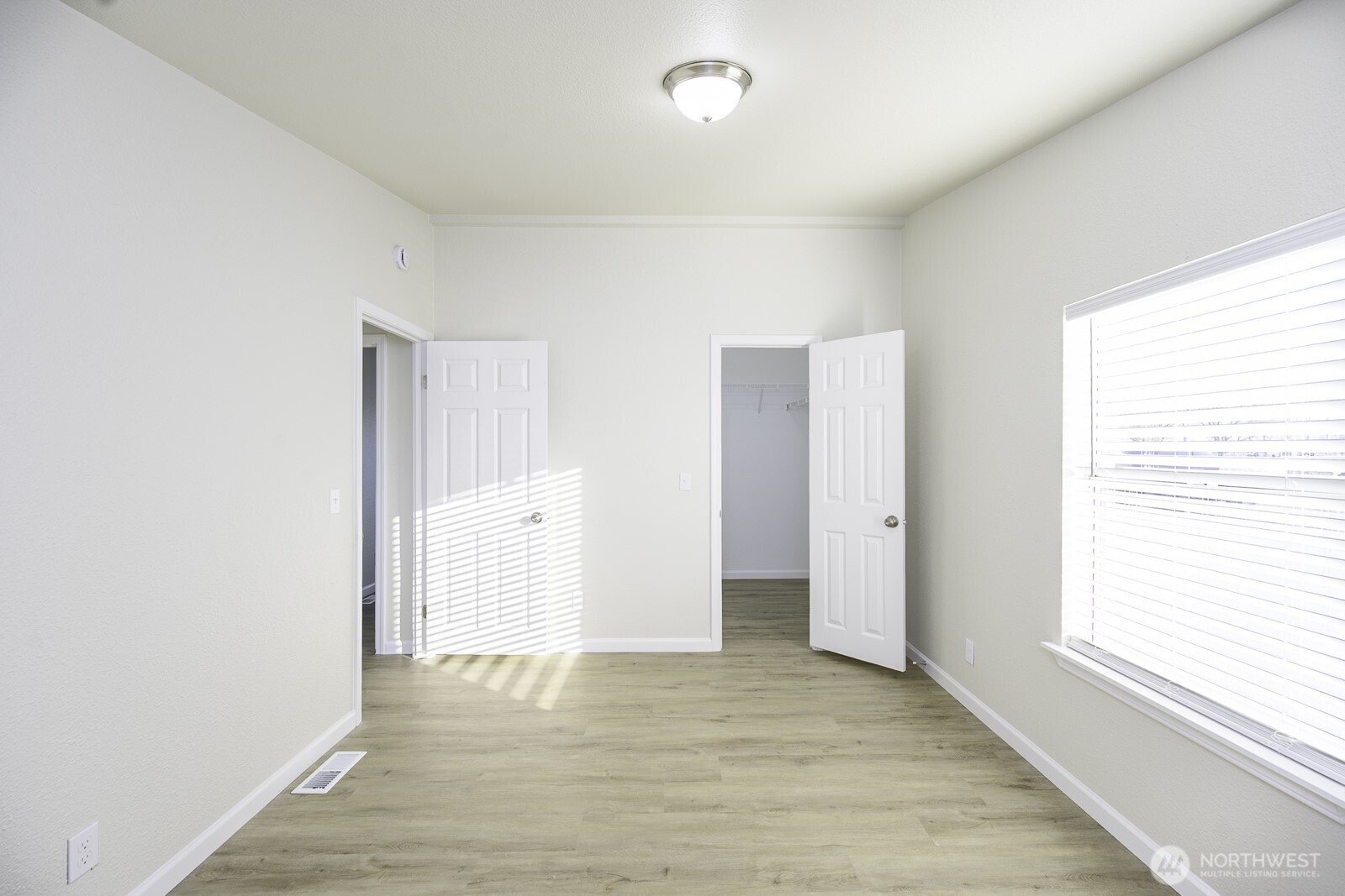 4948 Northeast E 7 Road Moses Lake, WA 98837 - Photo 16 of 22 a view of an empty room with wooden floor and a window