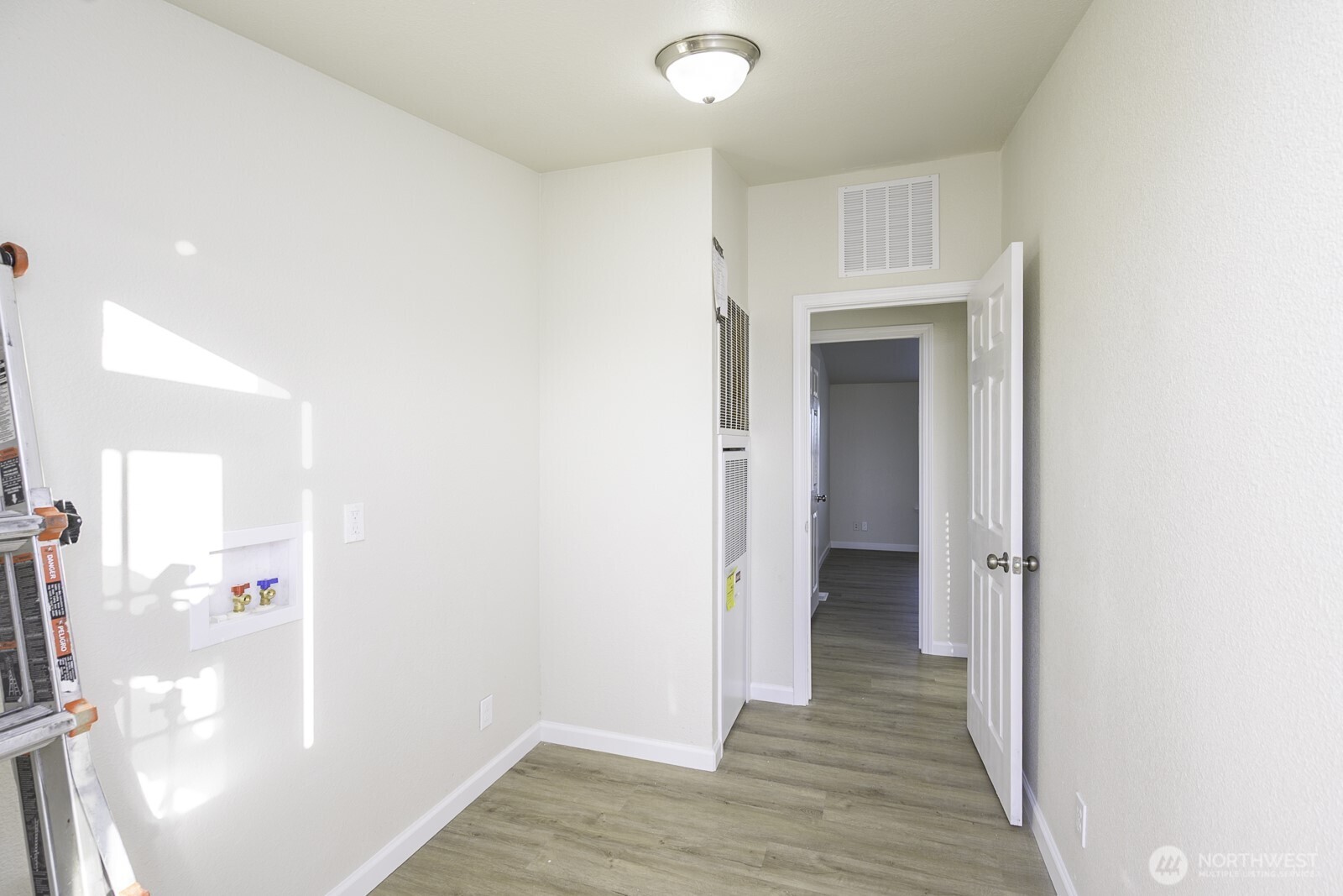 4948 Northeast E 7 Road Moses Lake, WA 98837 - Photo 18 of 22 a view of a hallway with wooden floor and staircase