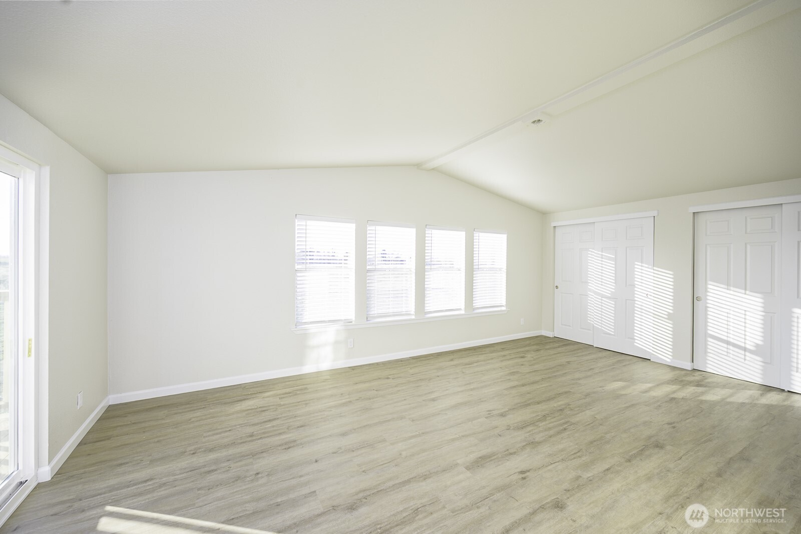 4948 Northeast E 7 Road Moses Lake, WA 98837 - Photo 19 of 22 an empty room with wooden floor and windows