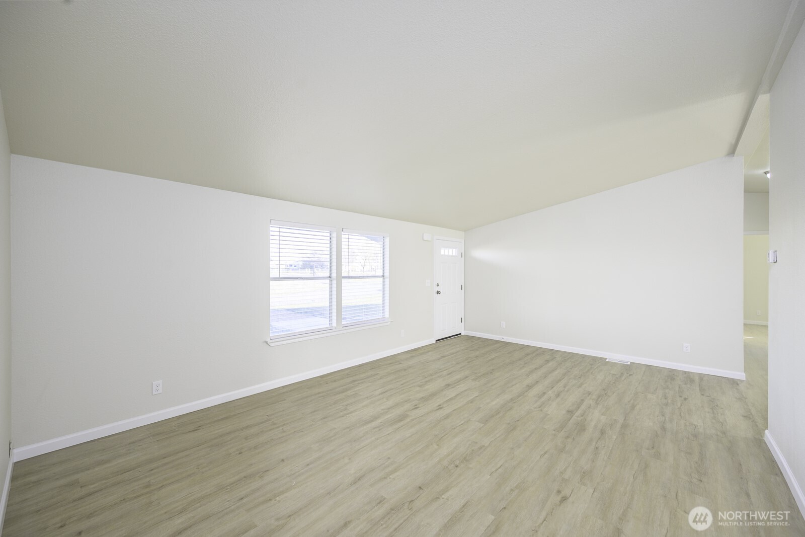 4948 Northeast E 7 Road Moses Lake, WA 98837 - Photo 7 of 22 an empty room with wooden floor and windows