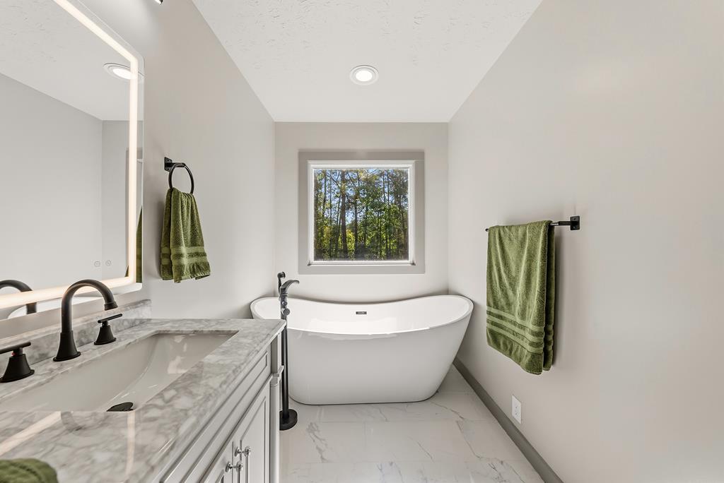 7313 Sesame Street Columbus, GA 31909 - Photo 15 of 43 a bathroom with a bathtub and a window