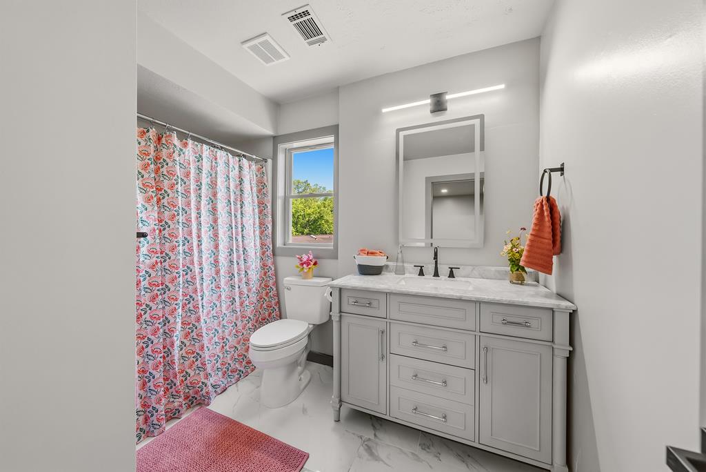 7313 Sesame Street Columbus, GA 31909 - Photo 23 of 43 a bathroom with a sink toilet and shower