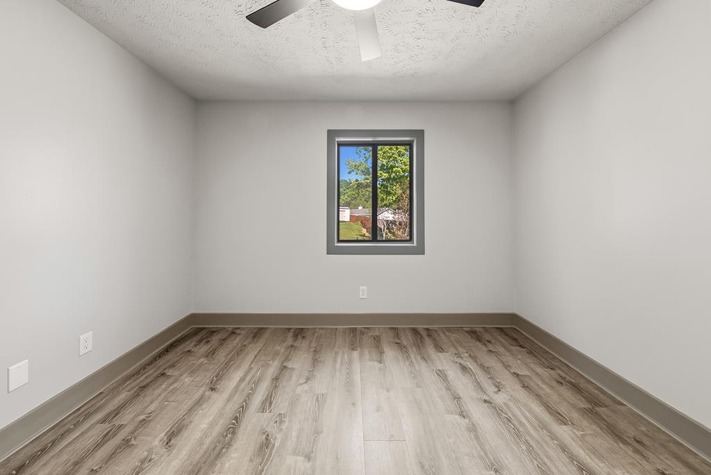 7313 Sesame Street Columbus, GA 31909 - Photo 28 of 43 wooden floor in an empty room with a window