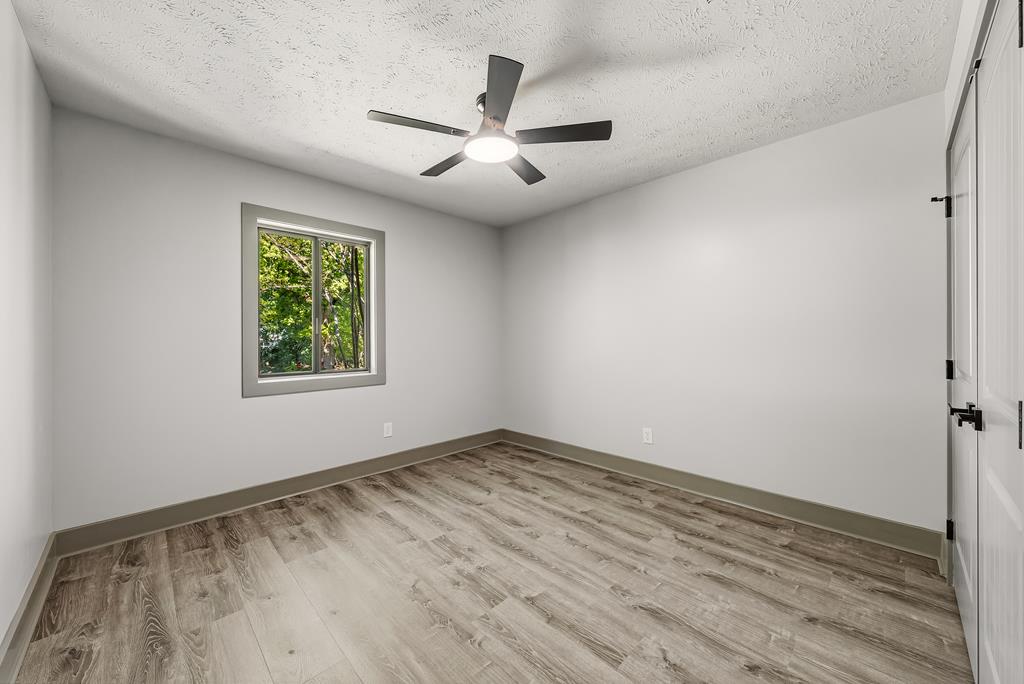 7313 Sesame Street Columbus, GA 31909 - Photo 29 of 43 wooden floor in an empty room with a window
