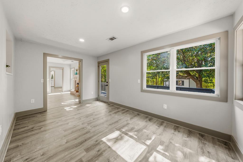 7313 Sesame Street Columbus, GA 31909 - Photo 31 of 43 a view of an empty room with wooden floor and windows