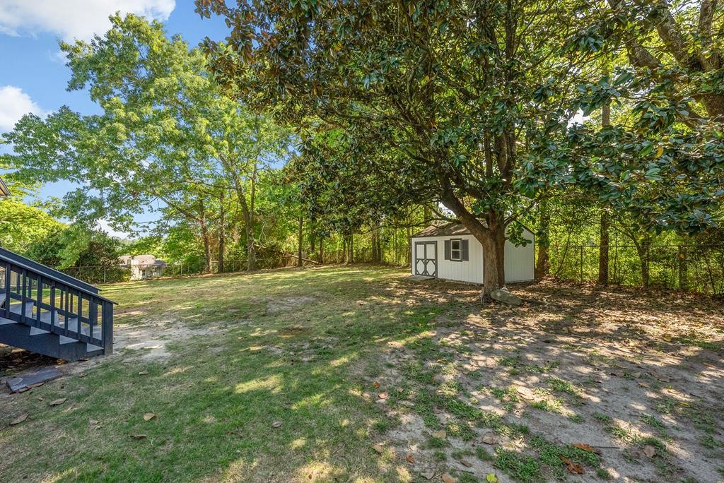 7313 Sesame Street Columbus, GA 31909 - Photo 35 of 43 a view of a yard in front of a house with large tree