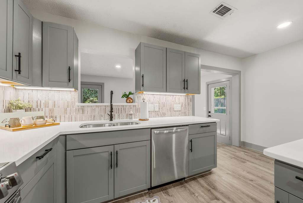 7313 Sesame Street Columbus, GA 31909 - Photo 5 of 43 a kitchen with a sink cabinets and wooden floor