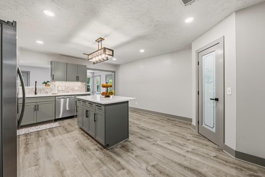 7313 Sesame Street Columbus, GA 31909 - Photo 6 of 43 a kitchen with stainless steel appliances granite countertop a stove oven and a refrigerator