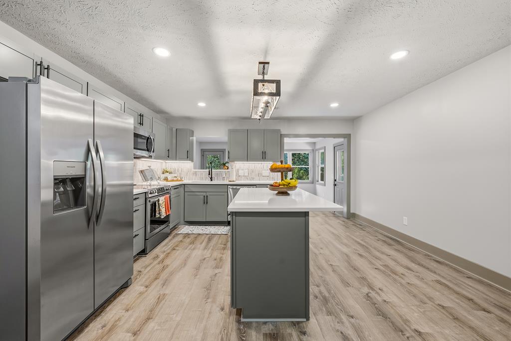 7313 Sesame Street Columbus, GA 31909 - Photo 7 of 43 a kitchen with stainless steel appliances a sink a stove a refrigerator cabinets and a dining table