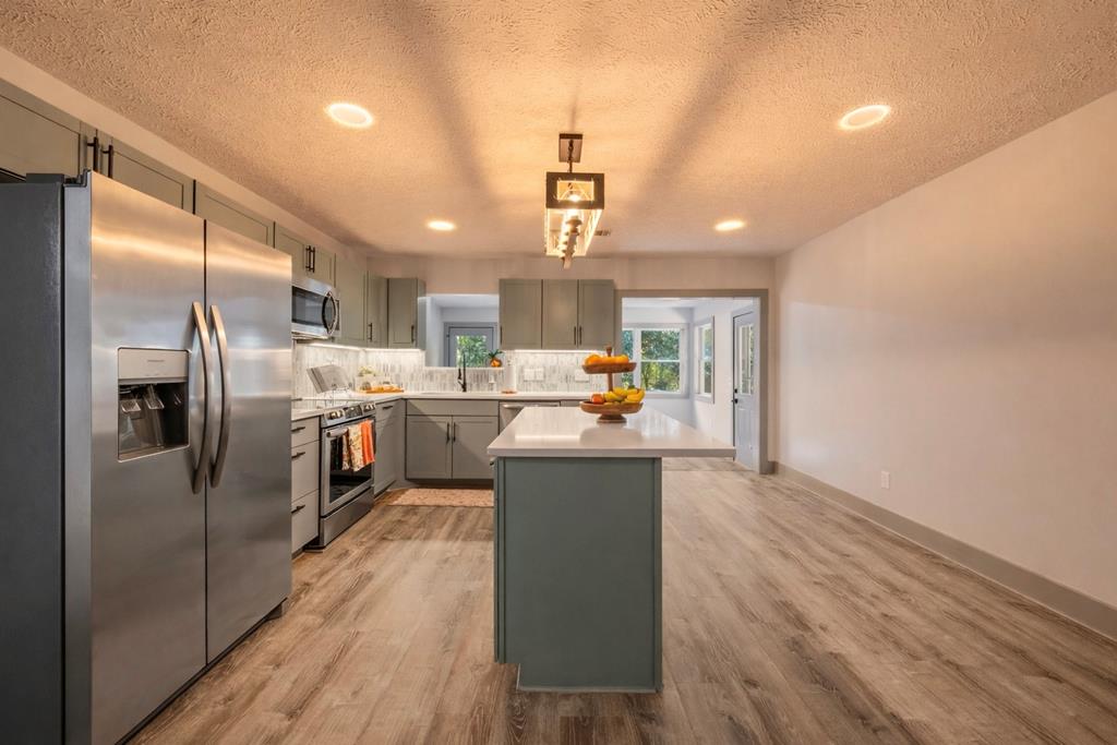 7313 Sesame Street Columbus, GA 31909 - Photo 9 of 43 a kitchen with stainless steel appliances granite countertop a refrigerator a sink dishwasher a stove and a refrigerator